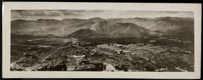 Panoramic view from above of a city, presumably on or near the Panama Canal with mountains beyond, 1913 by Byron Company